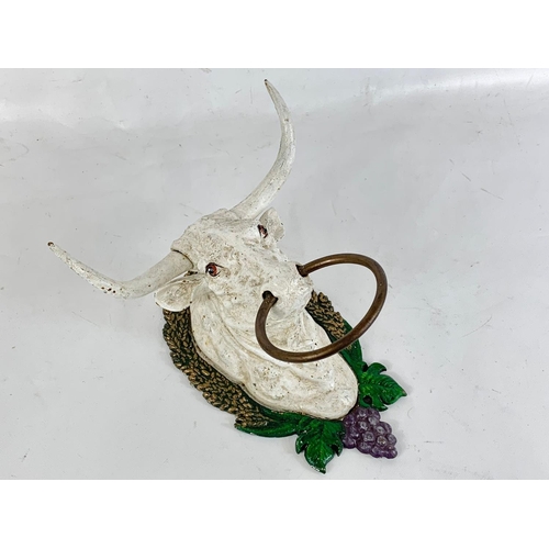 195 - A cast iron bull head.  17cm