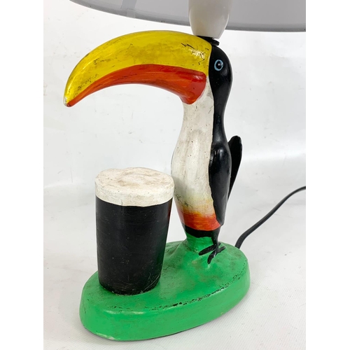 219 - A Toucan Guinness lamp. 41cm