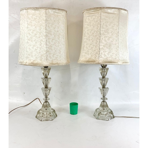 221 - A pair of ornate cut glass lamps. 80cm