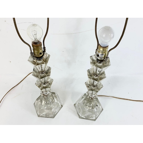 221 - A pair of ornate cut glass lamps. 80cm