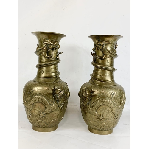 254 - A pair of large early 20th century brass Oriental vases with dragon decoration.  42cm