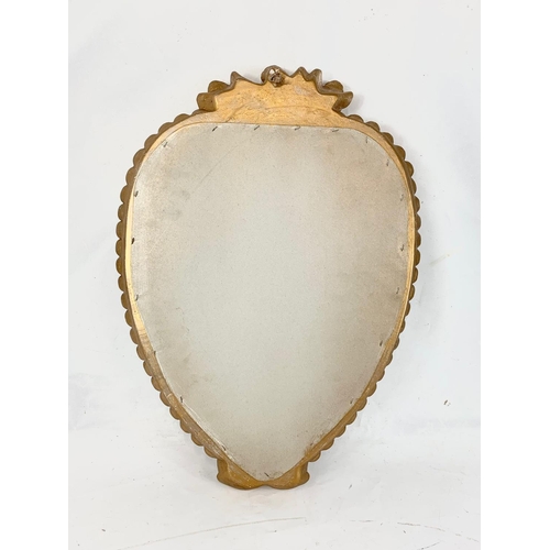 267 - A gilt framed heart shaped mirror with cherubs