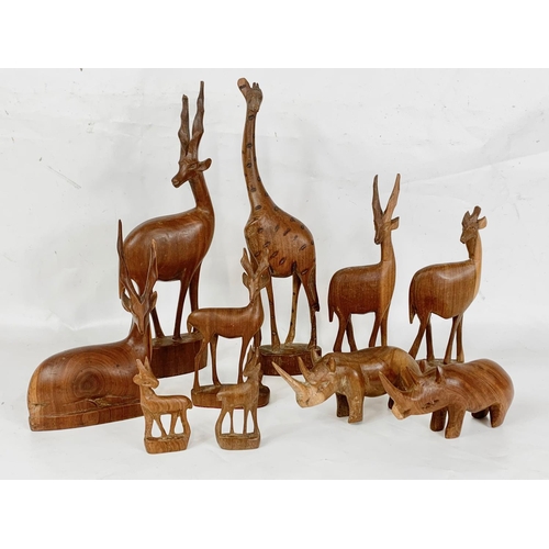 27 - A quantity of carved wooden animals, 36cm