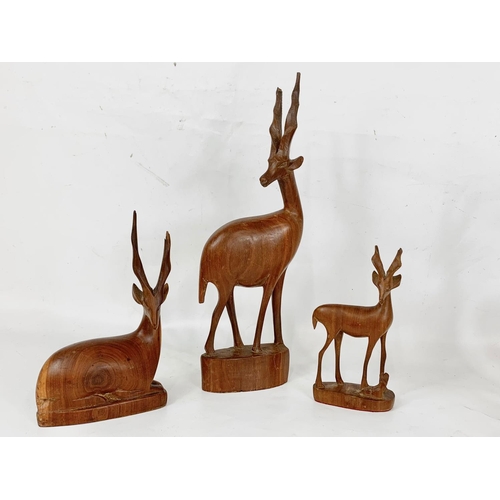 27 - A quantity of carved wooden animals, 36cm