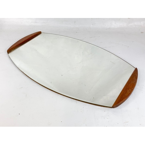 322 - A mid century teak framed mirror.  66x38cm