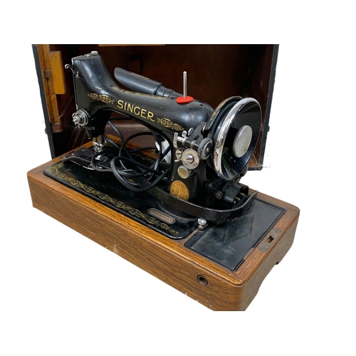 387 - A vintage electric Singer sewing machine in case.