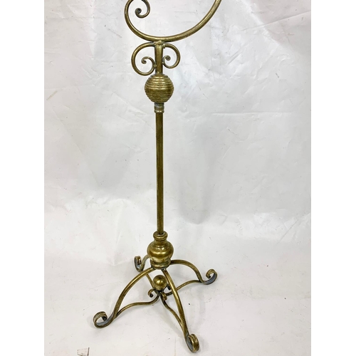 69 - An ornate brass candle stand, 160cm