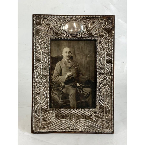 692 - An Art Nouveau silver mounted photo frame.  Chester mark.  23.5x16.5cm