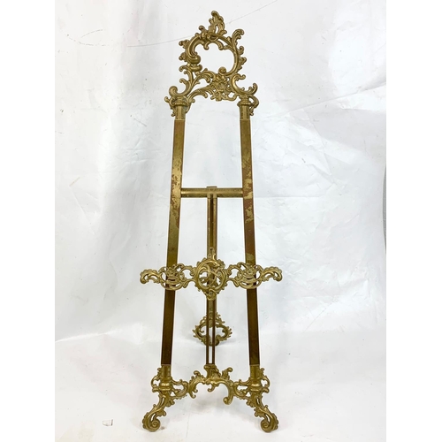 71 - A large ornate brass easel, 39cm x 114cm