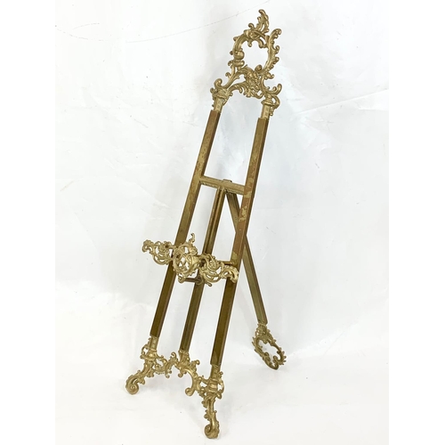 71 - A large ornate brass easel, 39cm x 114cm