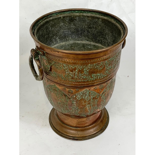 75 - An early 20th century Middle Eastern copper jardinière, 23cm x 27.5cm