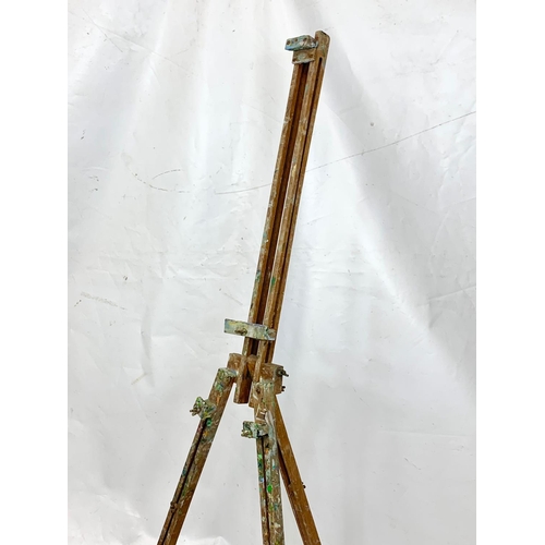 76 - A 1950s easel with paint box, 134cm