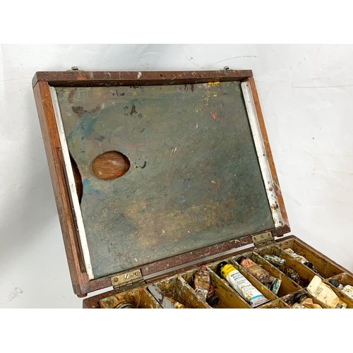 76 - A 1950s easel with paint box, 134cm