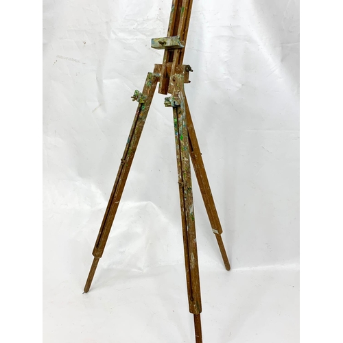 76 - A 1950s easel with paint box, 134cm