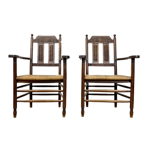 811 - A pair of Edwardian oak country armchairs with Aesthetic Movement influence