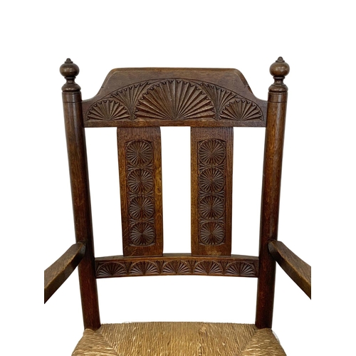 811 - A pair of Edwardian oak country armchairs with Aesthetic Movement influence