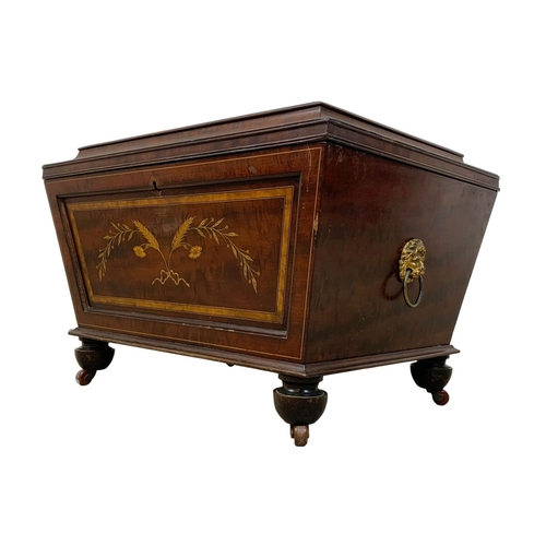 813 - A 19th century inlaid mahogany wine cooler in the sarcophagus shape and Sheraton style circa 1870s. ... 