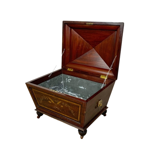 813 - A 19th century inlaid mahogany wine cooler in the sarcophagus shape and Sheraton style circa 1870s. ... 