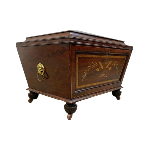 813 - A 19th century inlaid mahogany wine cooler in the sarcophagus shape and Sheraton style circa 1870s. ... 