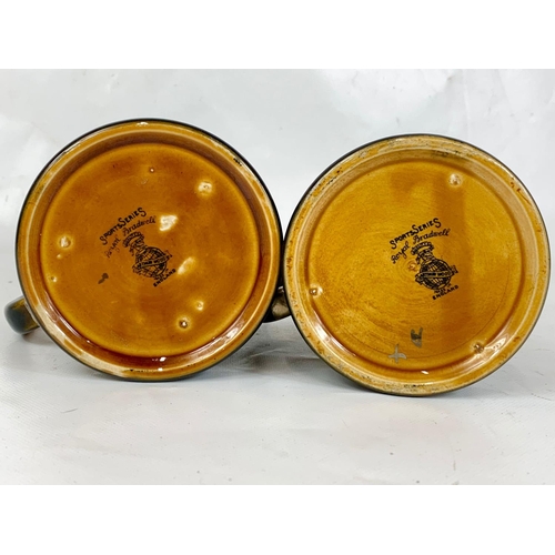 85 - A pair of early 20th century lustre mugs Sports series Arthur Wood, 13cm