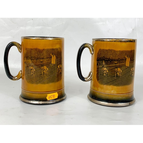 85 - A pair of early 20th century lustre mugs Sports series Arthur Wood, 13cm