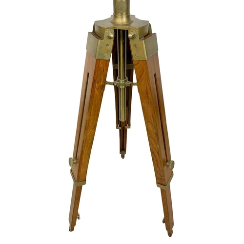 93 - A large brass search light style lamp on tripod stand, 136cm