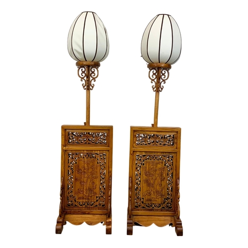 810 - A pair of very ornate Chinese elm floor lamps.  200cm extended, 157cm lowered.