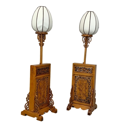 810 - A pair of very ornate Chinese elm floor lamps.  200cm extended, 157cm lowered.