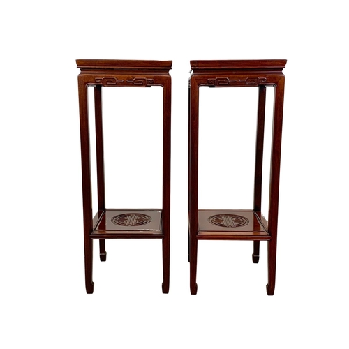 811 - A pair of rosewood Chinese pedestal stands. 80cm