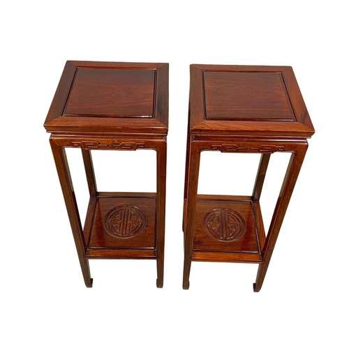 811 - A pair of rosewood Chinese pedestal stands. 80cm