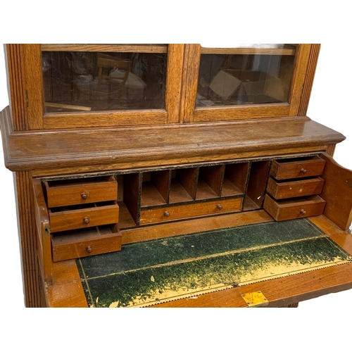 873 - A large Victorian oak secretaire bookcase. 122 x 51.5 x 255cm.