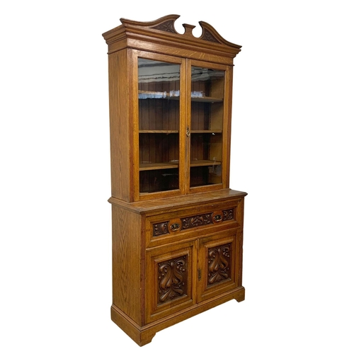 873 - A large Victorian oak secretaire bookcase. 122 x 51.5 x 255cm.