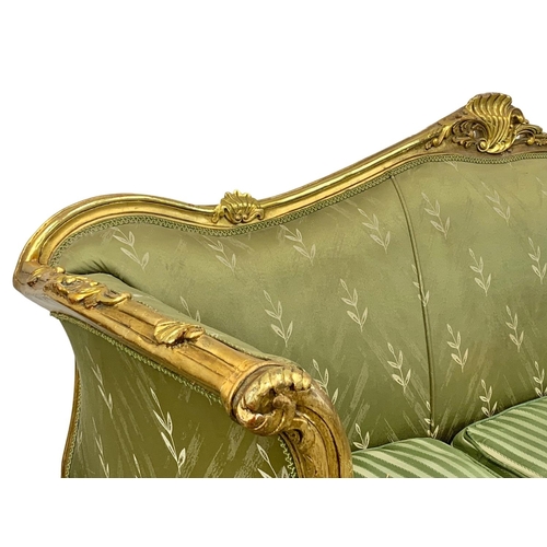 920 - A large vintage 18th century style French gilded chateau couch. 233cm