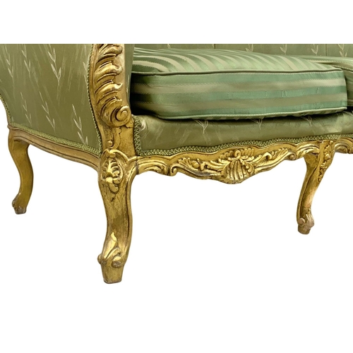 920 - A large vintage 18th century style French gilded chateau couch. 233cm