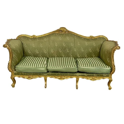 920 - A large vintage 18th century style French gilded chateau couch. 233cm