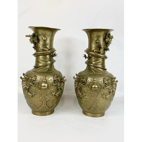 233 - A pair of large early 20th century brass Oriental vases with dragon decoration.  42cm