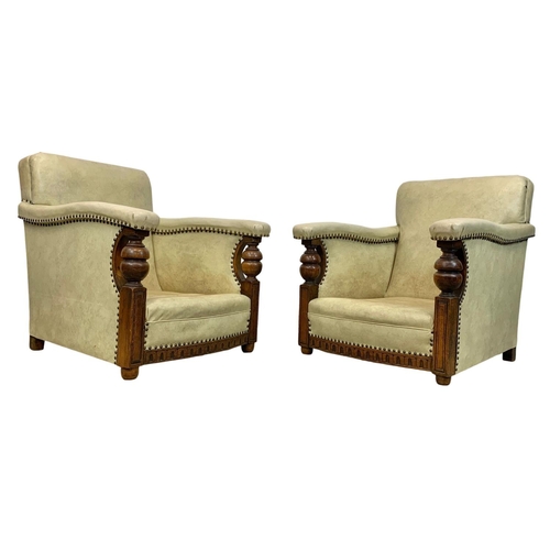 952 - A pair of large carved oak framed armchairs with original leather and new cushions with botanic patt... 