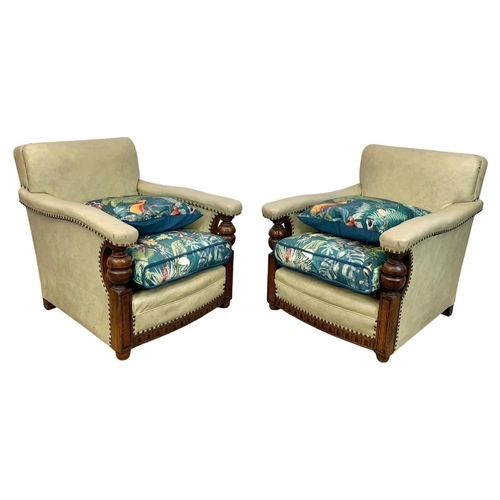 952 - A pair of large carved oak framed armchairs with original leather and new cushions with botanic patt... 