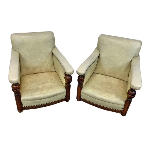 952 - A pair of large carved oak framed armchairs with original leather and new cushions with botanic patt... 