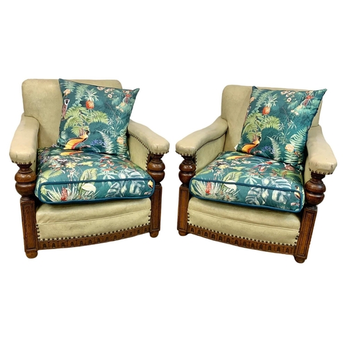 952 - A pair of large carved oak framed armchairs with original leather and new cushions with botanic patt... 