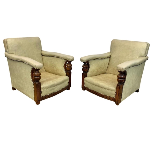 952 - A pair of large carved oak framed armchairs with original leather and new cushions with botanic patt... 