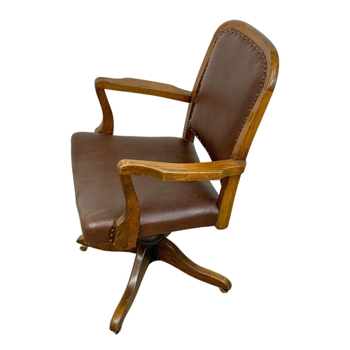 875a - An early 20th century oak office swivel chair.