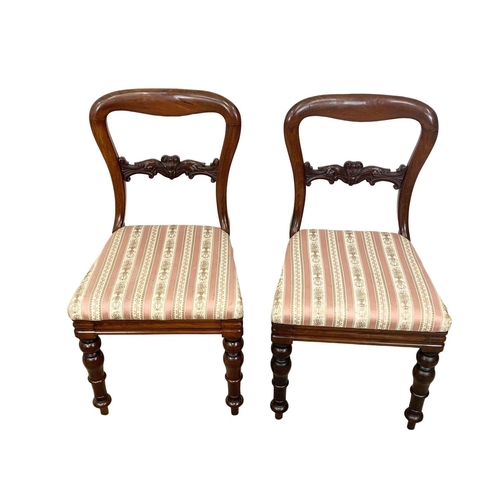 957 - A pair of Victorian balloon back chairs.