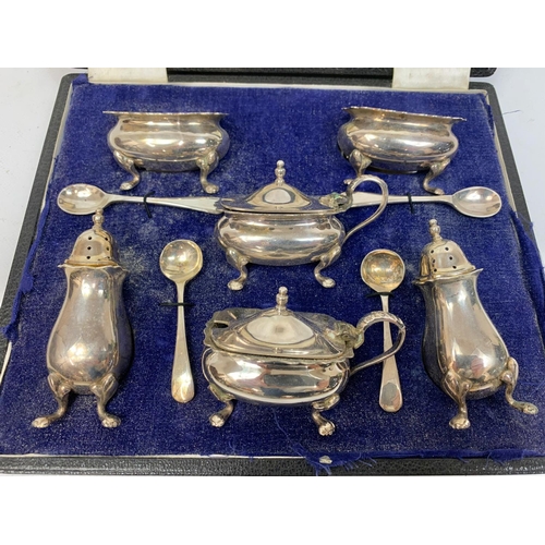 608 - A silver plated cruet set in case stamped Walker & Hall, Sheffield.