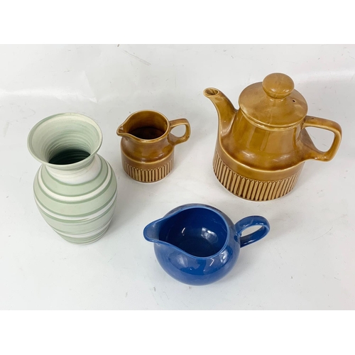 621 - A Carrig Irish glazed pottery tea pot and milk jug, with a Poole Pottery jug and another vase.