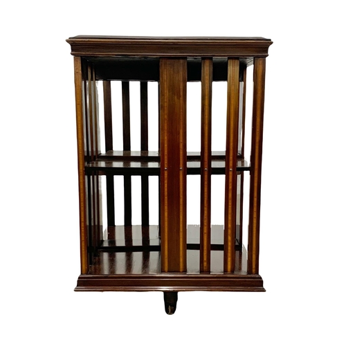 1033 - An Edwardian inlaid revolving bookcase, 55.5cm x 82.5cm