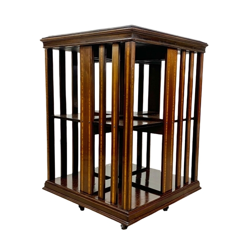 1033 - An Edwardian inlaid revolving bookcase, 55.5cm x 82.5cm