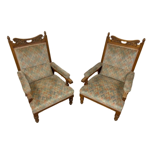 1062 - A pair of large Edwardian oak armchairs.