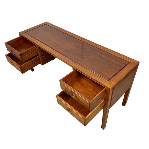 1065 - A large Chinese teak and rosewood desk.  153x49x71cm