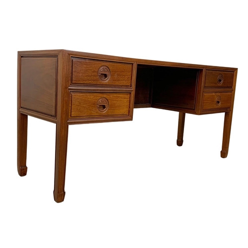 1065 - A large Chinese teak and rosewood desk.  153x49x71cm